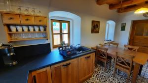 a kitchen with a table and a dining room at Sudetský grunt Autentická jesenická chalupa in Loučná nad Desnou
