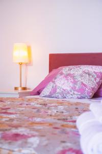 a bed with a pillow and a lamp on a table at Oliveta del Tabernacolo in Malmantile +27 photos