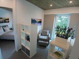 a bedroom with a bed and a desk and a chair at Bungalow Vulkanblick in Manderscheid