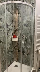 a shower in a bathroom with a stone wall at Luxury Central Monarch Residence Apartment Sleeps 5 in Timişoara +71 photos