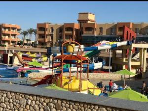 a pool with a water park with a water slide at Nozha Beach للعائلات in Ras Sedr