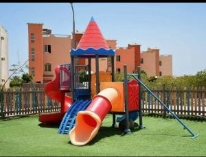 a playground with a slide in a park at Nozha Beach للعائلات in Ras Sedr