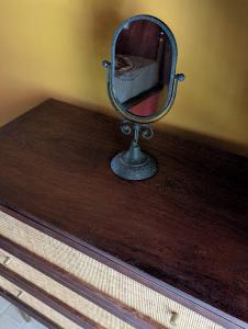 a mirror sitting on top of a wooden table at ZenGardenCV in Lazareto