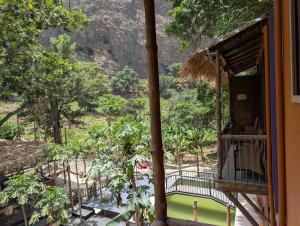 a balcony of a house with a view of a mountain at ZenGardenCV in Lazareto +8 photos