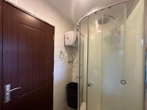 a bathroom with a shower and a glass door at Aurora in Carmelo +6 photos