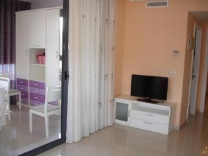 a living room with a television and a tv stand at Gemelos 26 - Zand Properties in Benidorm