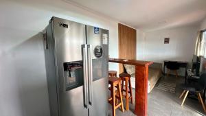 a kitchen with a stainless steel refrigerator and a table at Aurora in Carmelo