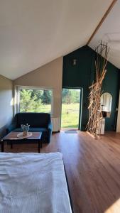a living room with a couch and a table at Domki Wieck in Czarna Woda
