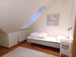 a bedroom with a bed with white sheets and a window at Dählie Åre Torg Apartments in Åre +64 photos