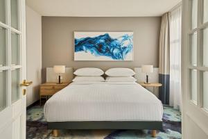 a bedroom with a bed and a painting on the wall at Hamburg Marriott Hotel in Hamburg