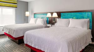 a hotel room with two beds and a window at Hampton Inn Chelsea, Mi in Chelsea