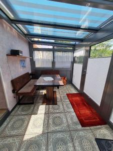 a room with a table and a bench and windows at Seestern in Rerik