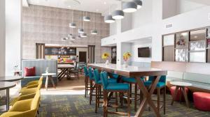 a dining room with a table and chairs at Hampton Inn Chelsea, Mi in Chelsea