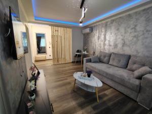 a living room with a couch and a table at David Apartament in Hunedoara