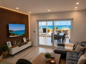 a living room with a couch and a tv and a table at Villa Dru in Roquetas de Mar
