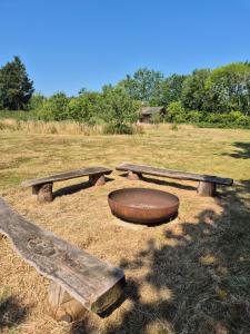 a group of three picnic tables in a field at Lyng Farm Campsite in Brisley +7 photos