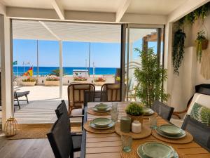 a dining room with a table and a view of the ocean at Villa Dru in Roquetas de Mar