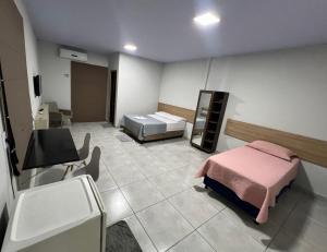 a hospital room with a bed and a sink at Apartamento privado in Primavera do Leste +5 photos