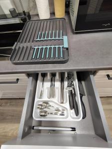 a drawer in a kitchen with utensils at David Apartament in Hunedoara