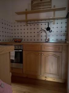 a kitchen with a sink and a stove at Ferienwohnung Kleine Auszeit in Bastheim +13 photos