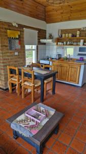 a kitchen with a table and chairs in a room at Cabañas Mateo in Villa Pehuenia