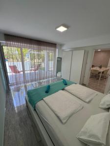 a bedroom with two beds and a large window at BB Riviera Resort in Balatonboglár