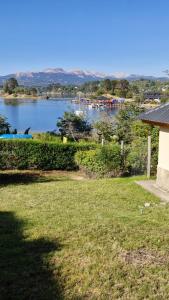 a view of a body of water with a house at Cabañas Mateo in Villa Pehuenia