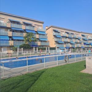 a swimming pool in front of a apartment building at MEDITERRÁNEO Benicarló NG in Benicarló