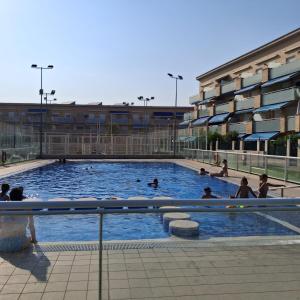 a group of people swimming in a swimming pool at MEDITERRÁNEO Benicarló NG in Benicarló +11 photos