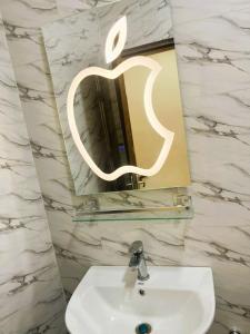 ein Apfelspiegel über einem Waschbecken im Badezimmer in der Unterkunft CAMMS 2 Studios in Rufisque + 61 Fotos