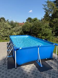 a large blue pool sitting on a patio at Domki Pod Jesionami in Stronie Śląskie