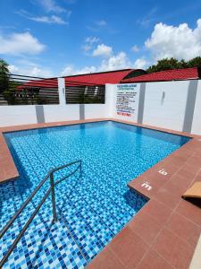 a large swimming pool with blue tiles on a building at JJPHR Hotel San Antonio in Lubao