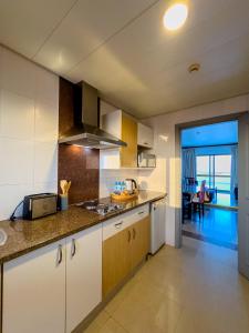 a kitchen with white cabinets and a counter top at Vip Executive Suites Maputo in Maputo