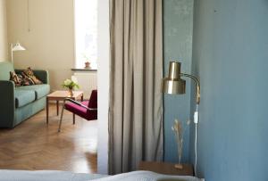 a living room with a couch and a living room with a couch at Spjutstorp's old school and rectory, 1 in Tomelilla