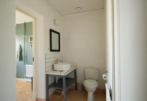 a bathroom with a sink and a toilet at Spjutstorp's old school and rectory, 1 in Tomelilla +12 photos