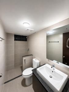 a bathroom with a white toilet and a sink at HomeWay Dhaka in Kāmarpāra