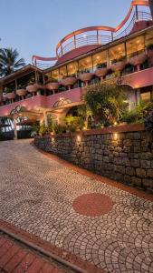 a large building with a brick road in front of it at Rose Villa Kovalam in Kovalam
