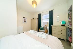a bedroom with a white bed and a window at The Copper Loft Apartment, Keith in Keith