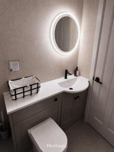 a bathroom with a sink and a mirror at The Copper Loft Apartment, Keith in Keith +36 photos