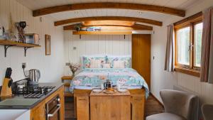a small bedroom with a bed in a tiny house at Betty Shepherd's Hut in Lydney