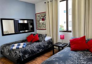 a living room with a couch and a television at Caribbean apartment in Cancún +49 photos