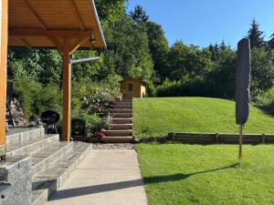 a stone walkway leading to a house with a garden at Altum Mátra Vendégház in Mátraszentimre