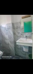 a bathroom with a sink and a mirror at Jaans Inn in Ratmalana South +23 photos