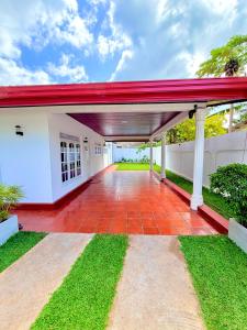 an empty patio of a house with a red roof at Villa 87 - Anuradhapura in Anuradhapura +20 photos