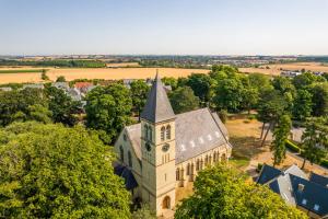 an aerial view of a church with a clock tower at The North Wing in Stotfold