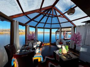 a room with a large glass ceiling with a view of the water at Sky Domo Titicaca Lodge in Puno