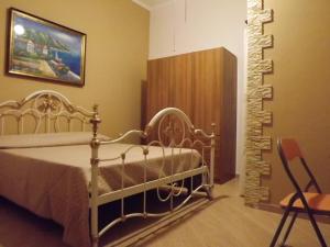 a bedroom with a metal bed in a room at B&B Il Girasole in Balestrate