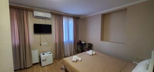a hotel room with a bed and a mirror at Mtskheta Pool and Veranda in Tsitsamuri