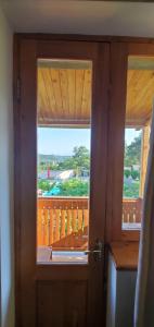 an open door with a view of a balcony at Mtskheta Pool and Veranda in Tsitsamuri