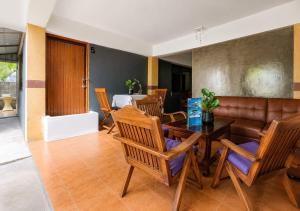 a dining room with a table and chairs and a couch at SU house Koh Phangan in Thong Nai Pan Yai